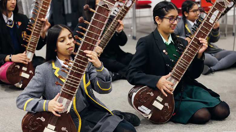 Birmingham's Services For Education ensemble Raga & Tala, playing the sitar in preparation for their Youth Proms