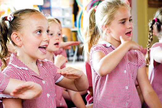  Year 2 children singing in solfa, with hand signs